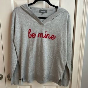 Long sleeve grey hooded sweater.